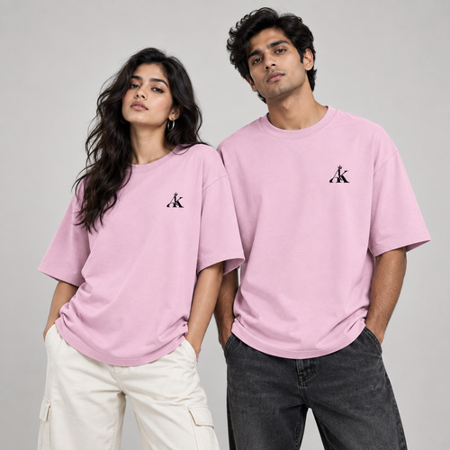 Man and woman wearing AK Luxury pastel pink unisex oversized T-shirts